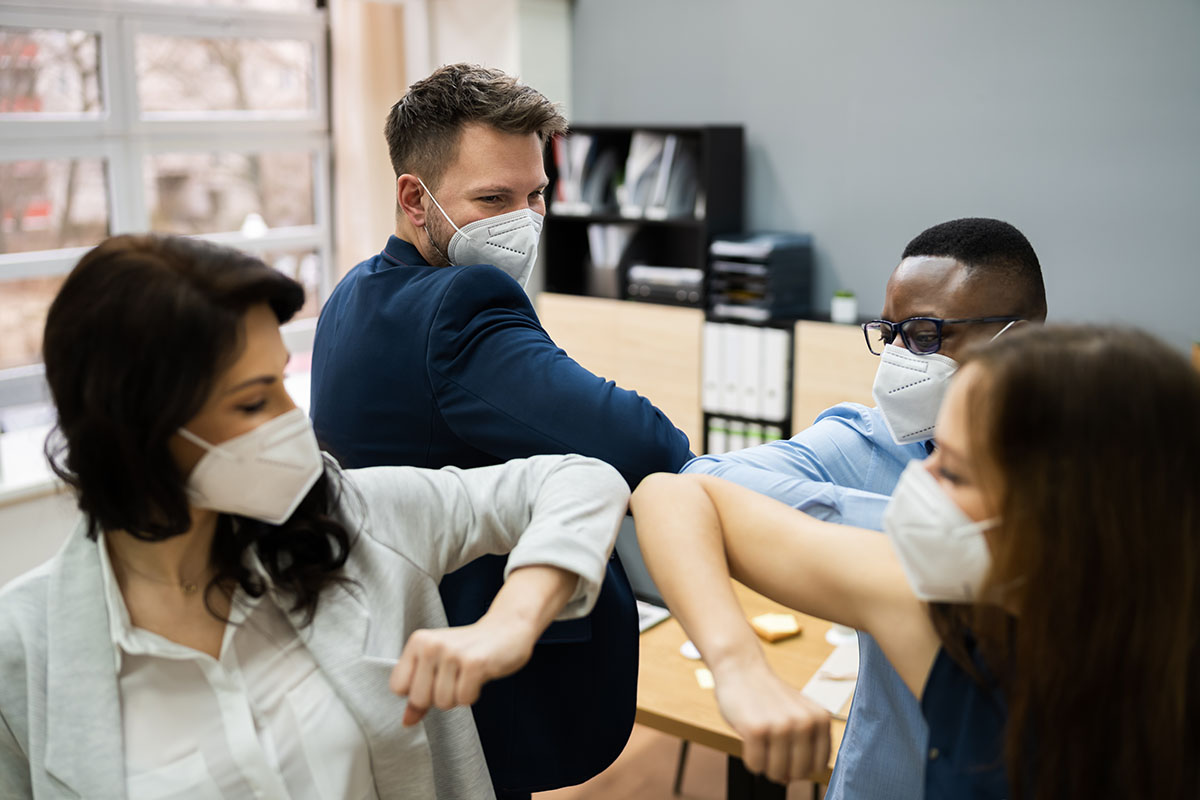 Business People Elbow Bump Wearing Covid Face Mask